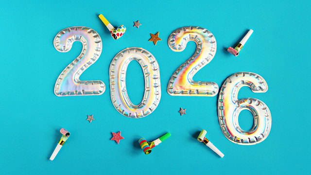 Shiny foil balloon numbers forming 2026